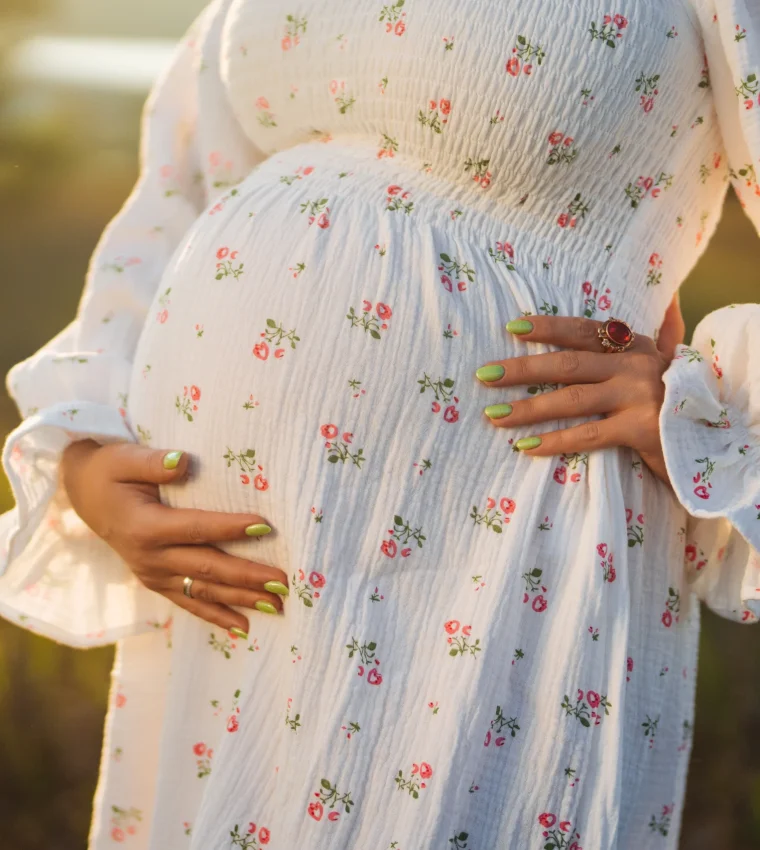 pregnant-woman-holding-baby-bump-outdoors-2026-03-19-10-38-27-utc_scaled